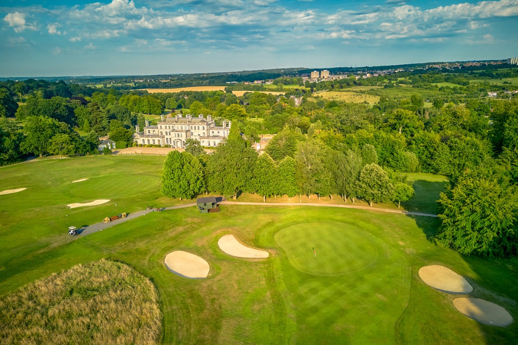 Aerial view of the 18th green at Addington Palace Golf Club, with Addington Palace in the background