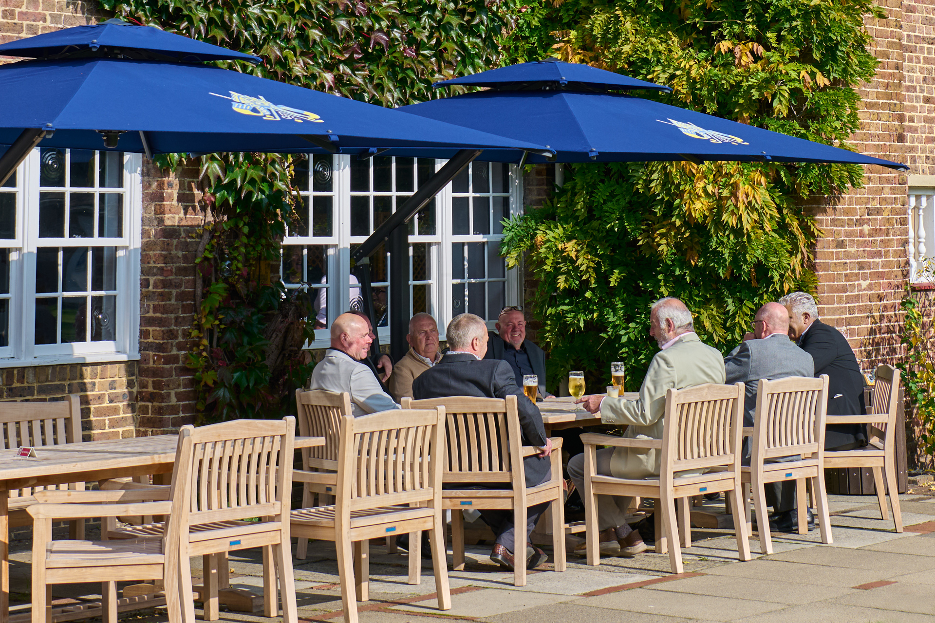 Addington Palace Golf Club members enjoying a drink and a chat outside at the clubhouse