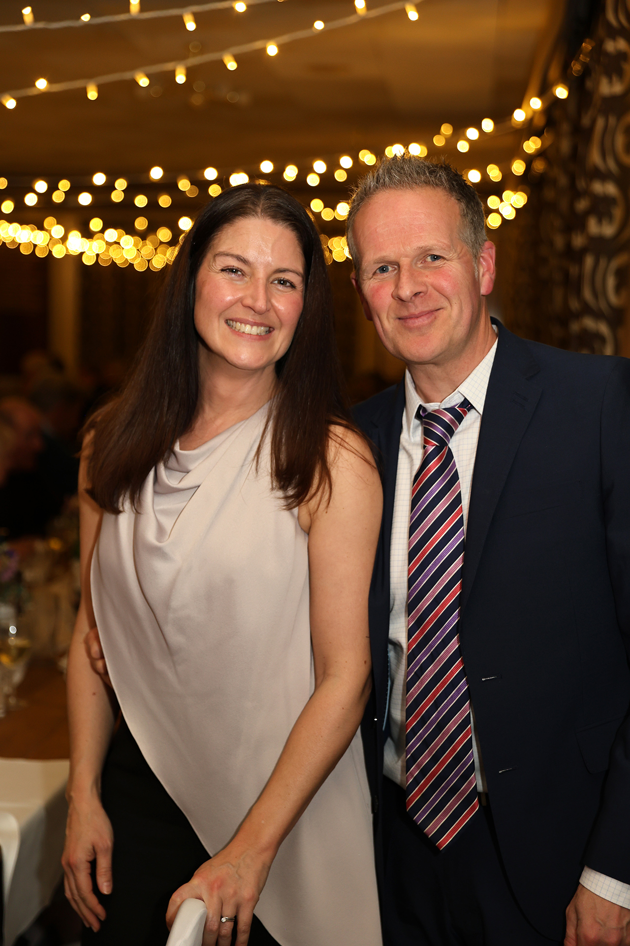 Two wedding reception guests smiling at the camera at Addington Palace Golf Club